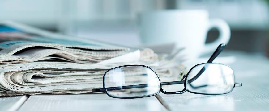Reading glasses & newspaper